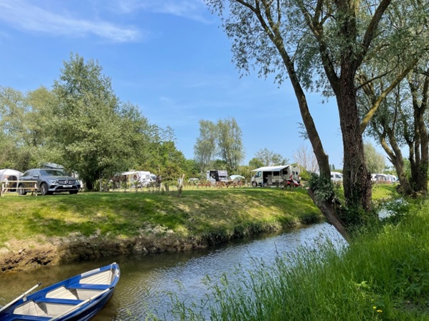 Campervans, caravans and tents at Three Rivers Campsite.