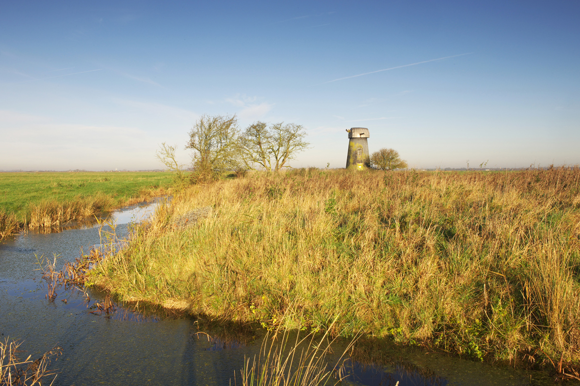 Golden light looking over a dilapidated mill and drainage dyke on Halvergate Marshes