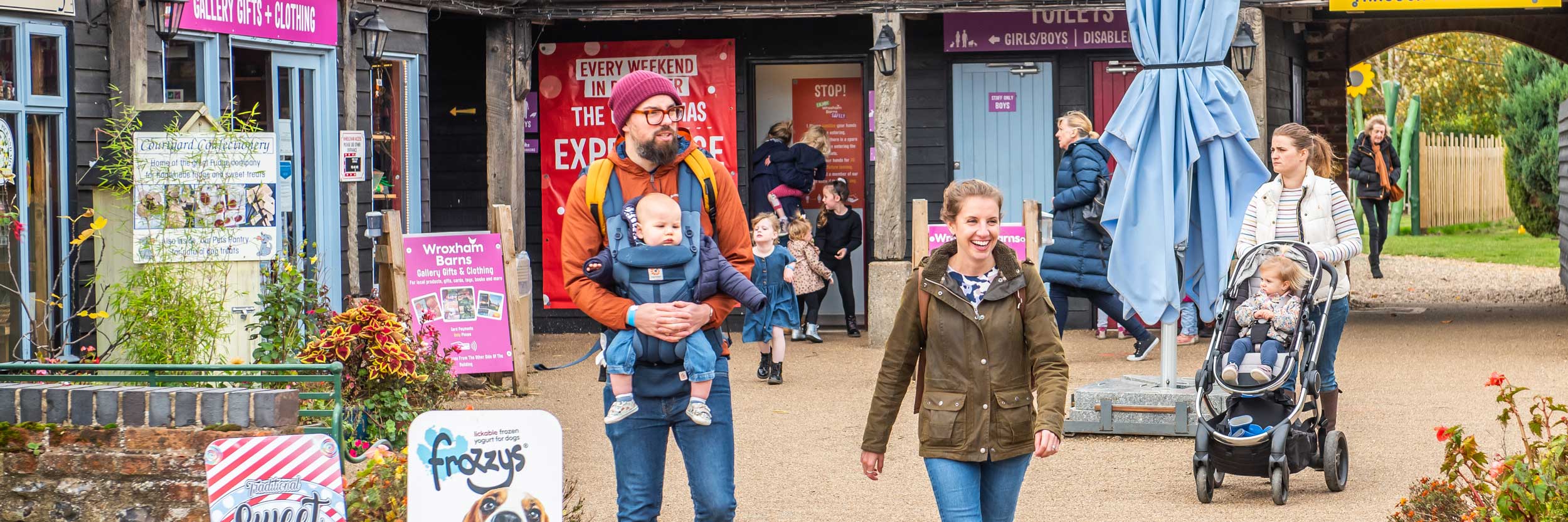 A family standing outside of Wroxham Barns