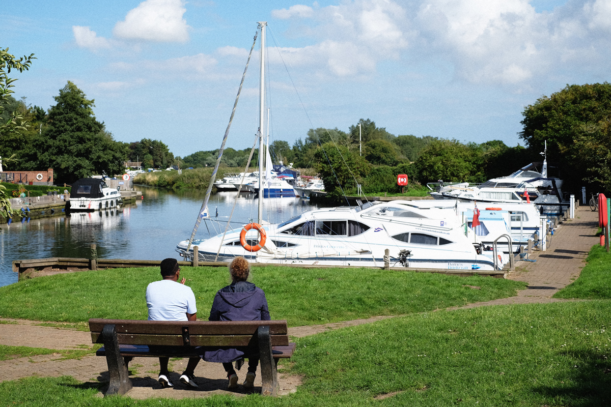 Overlooking boats moored at Loddon Staithe with the River Chet in the distance