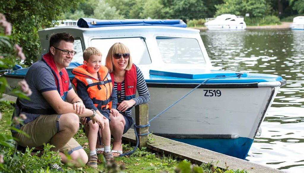 Day boat hire, family enjoying a day on the Norfolk Broads
