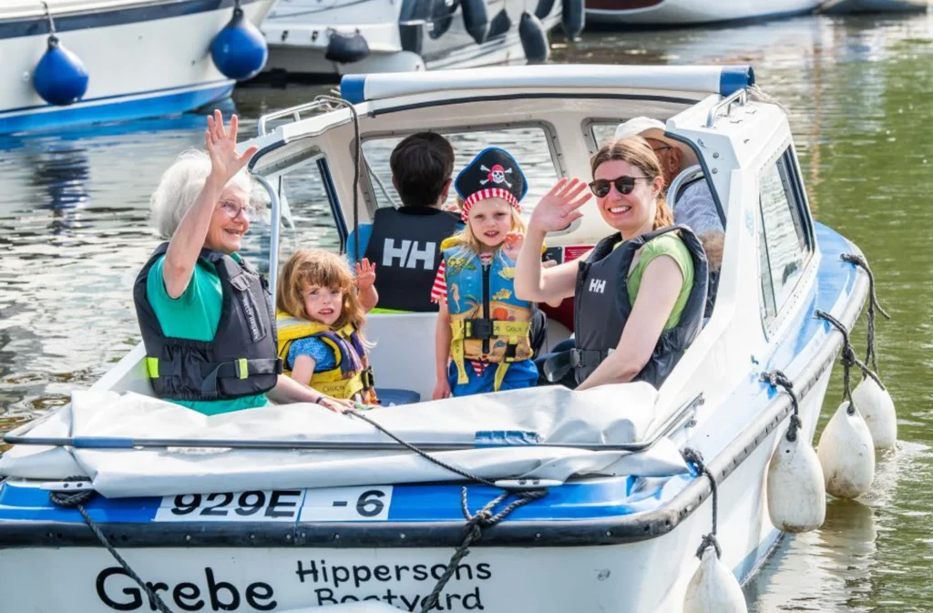 Family enjoying self-drive day boat on the Norfolk Broads
