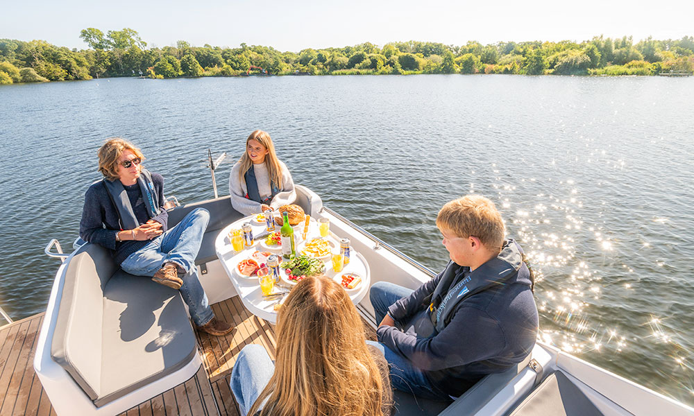 Friends relaxing on deck of a Barnes Brinkcraft self-drive holiday boat