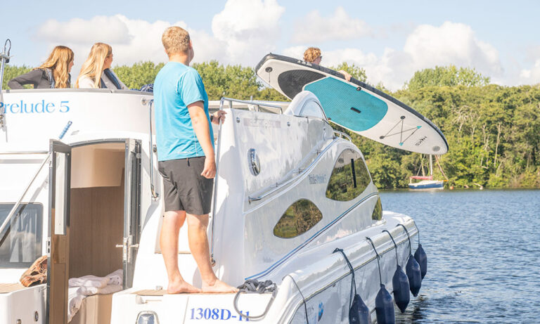Family enjoying a Norfolk Broads boating holiday on a Barnes Brinkcraft cruiser