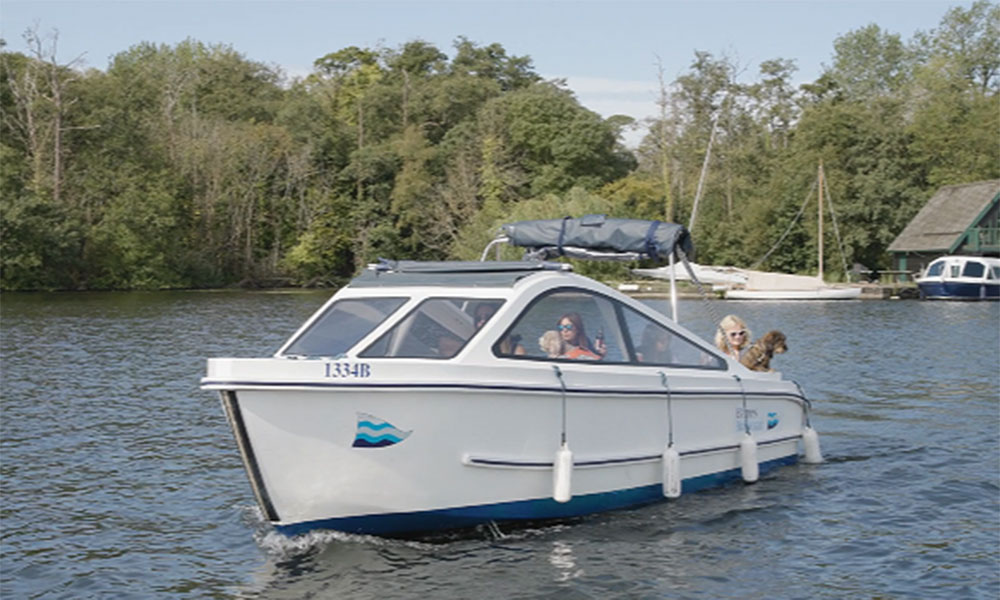 Riverside scene with Barnes Brinkcraft boats ready for hire in Wroxham