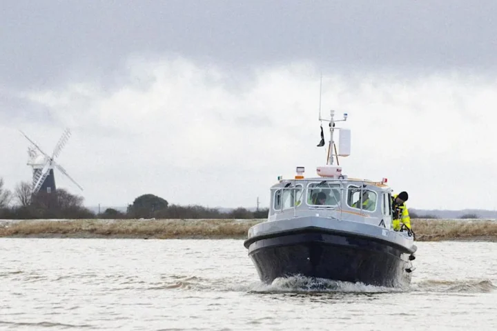 A boat crossing Breydon water in slightly choppy conditions