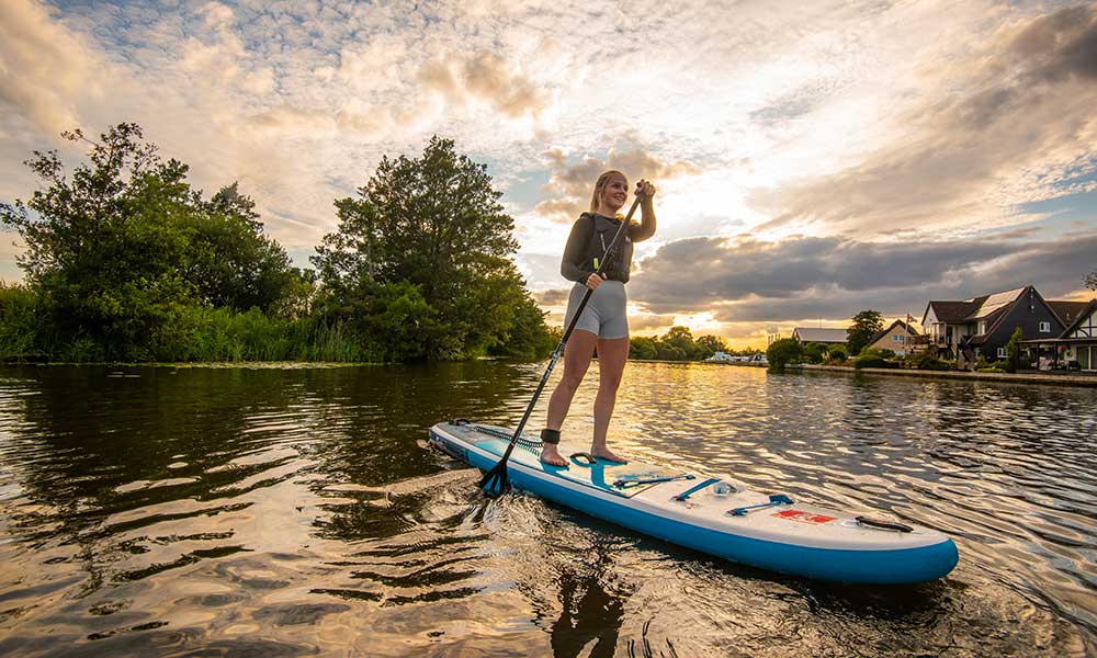 Sunset paddleboarding on peaceful Broads waterways