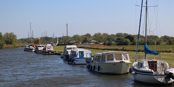 Boats moored along riverbank at Martham