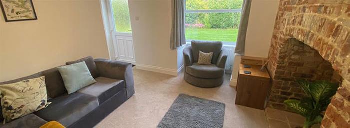 Bright living room inside Horstead holiday cottage