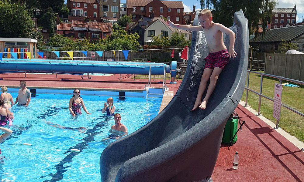 A youngster enjoying the slide at Beccles Lido, on a very sunny day