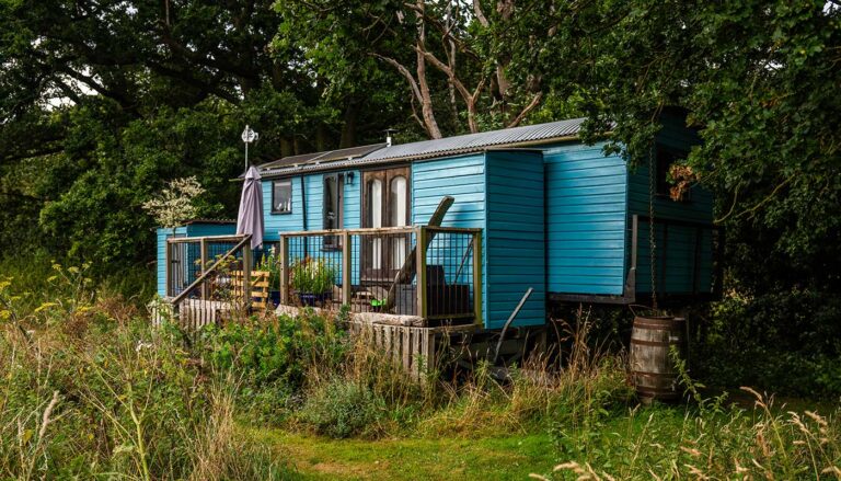 A cozy glamping cabin, with decking, set in a green rea