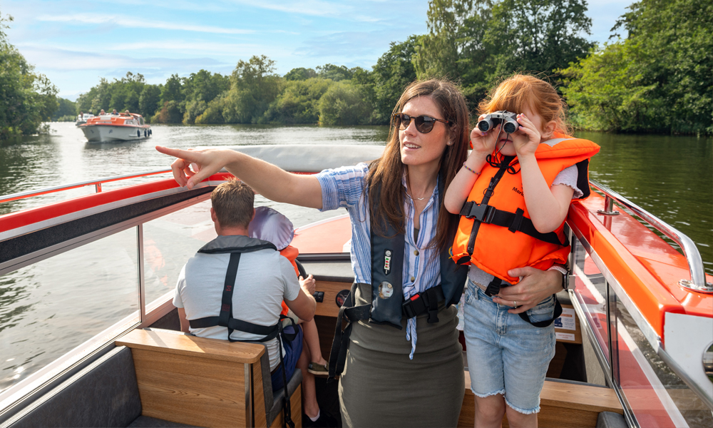 Family enjoying a day boat trip on the Broads