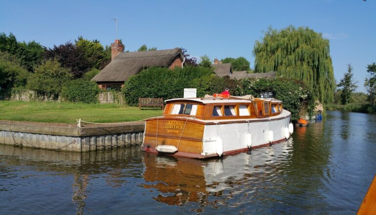 A traditional wooden holiday cruiser on The Broads