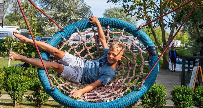 Child playing on a swing in an outdoor playground