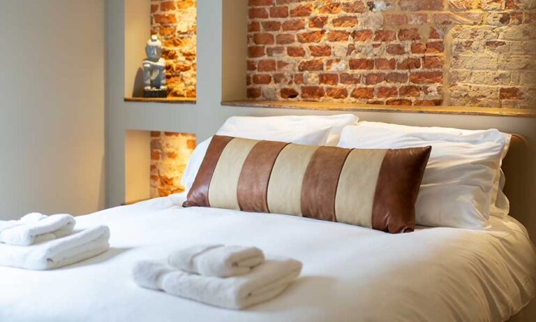 Boutique hotel bedroom with luxury linens in Aylsham
