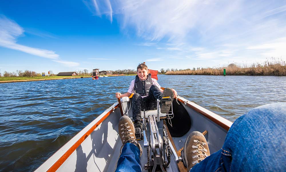 Enjoying a pedal boat in the Southern Broads, with wide blue skies