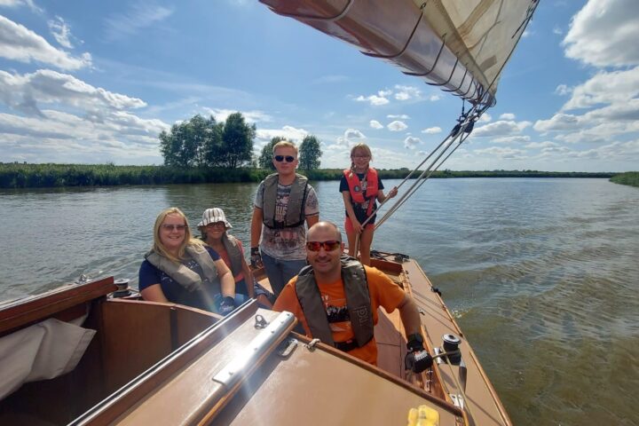 Family enjoying sailing in the Norfolk Broads