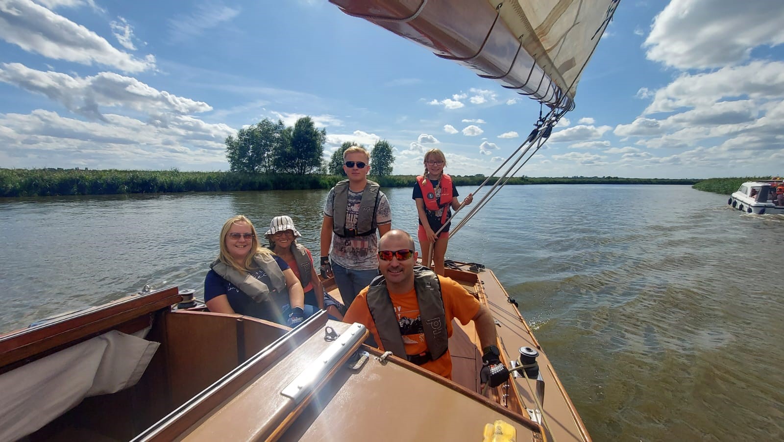 Family enjoying sailing in the Norfolk Broads