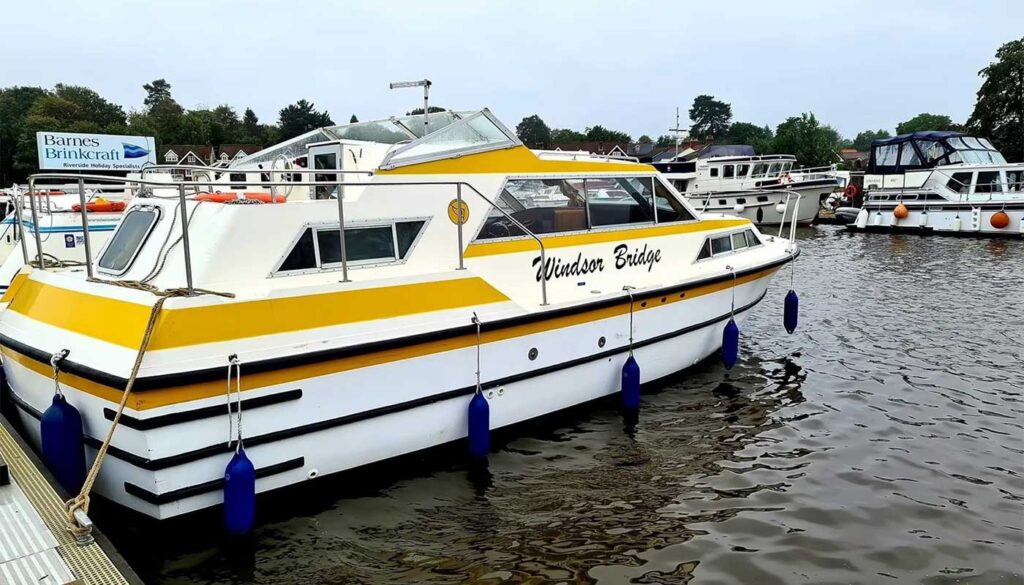A Norfolk Broads Cruiser from Bridgecraft Boatyard. Yellow and white.