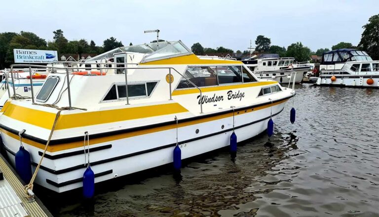 A Norfolk Broads Cruiser from Bridgecraft Boatyard. Yellow and white.